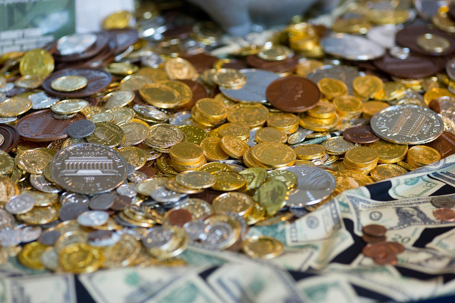 Image of gold and silver coins on a table with a black table cloth