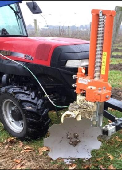 Figure 4. Front mounted specialized rotary implement for hilling up grapes with gauge wheel. 