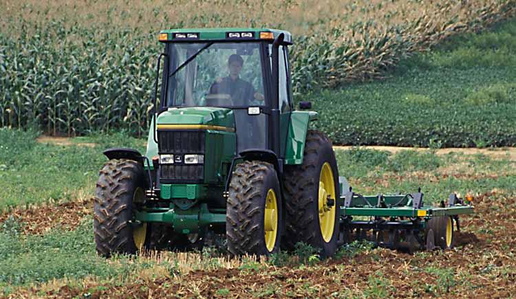 Farmer in tractor in field. Photo: Edwin Remsberg