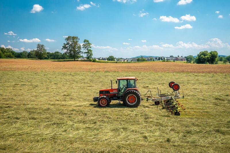 Red Tractor in a Hay field by Edwin Remsberg