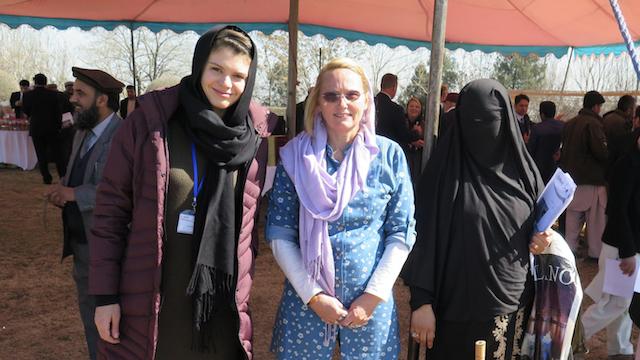 From left to right, Taryn Devereux, Sophia Wilcox, and Layluma standing in front of fencing