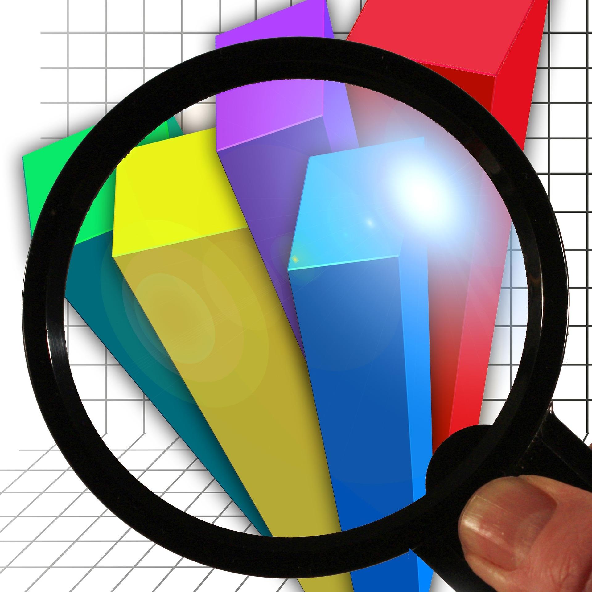 Magnifying glass looking at bar graph