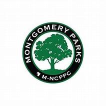 Emblem with Montgomery Parks MNCPPC written in black and a green tree in center