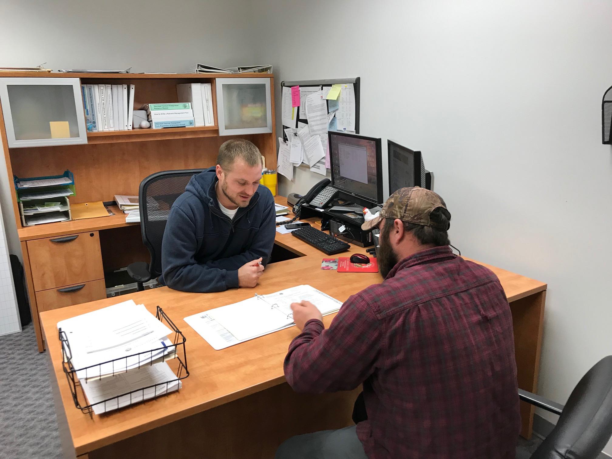 Consultant delivering plan to farmer