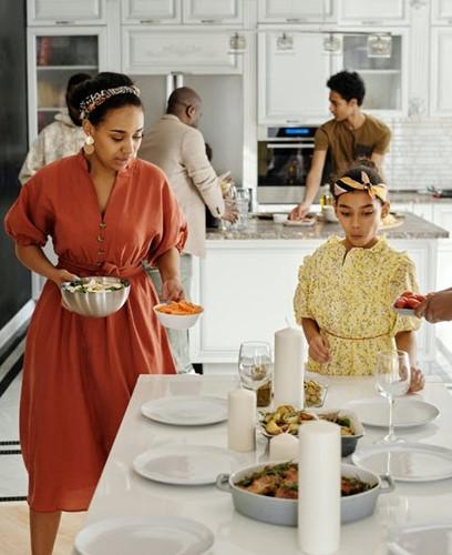 Family setting the dinner table.