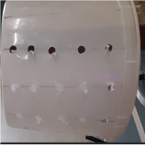 White mixing container with 3/8 inch holes on all sides.