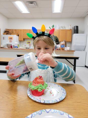 Chesapeake Clovers 4-H Member decorating cupcake